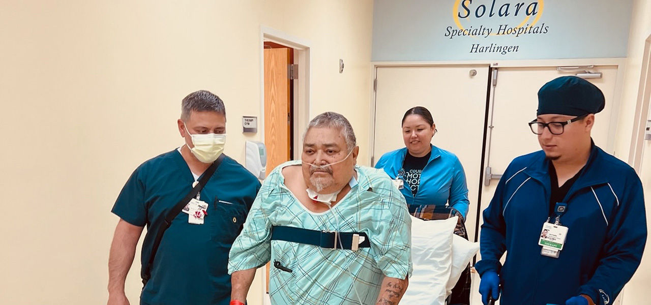Solara Specialty Hospital Harlingen patient Juan walks with his care team 